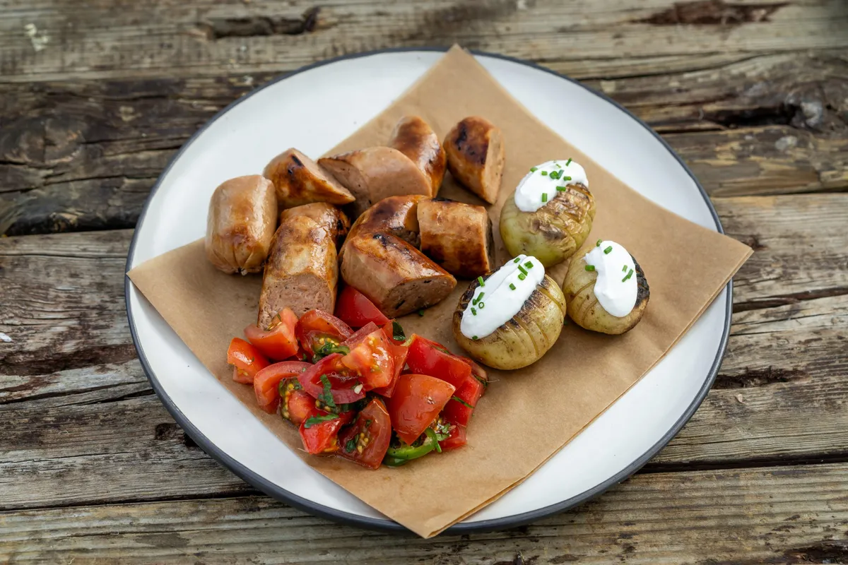 Bratwurst with Baked Potatoes and Tomato Salad