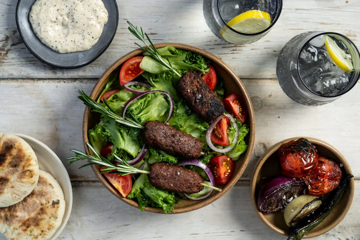 Lamb Kofta on Rosemary Sprig Skewers alongside fresh salad