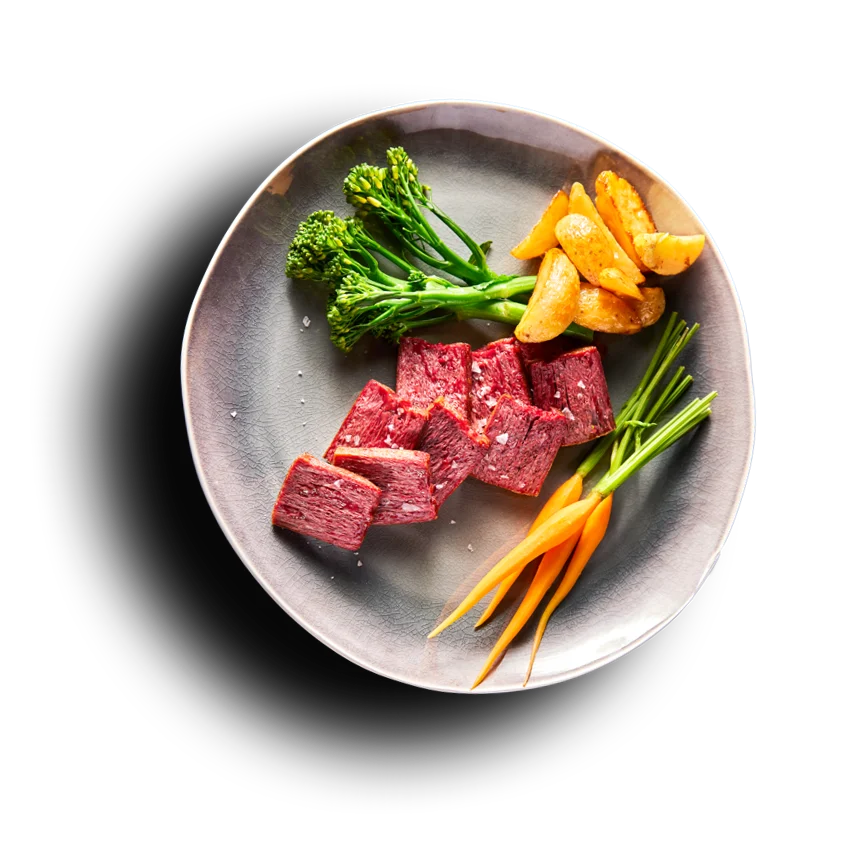 Redefine Meat pieces plated with broccoli and carrots