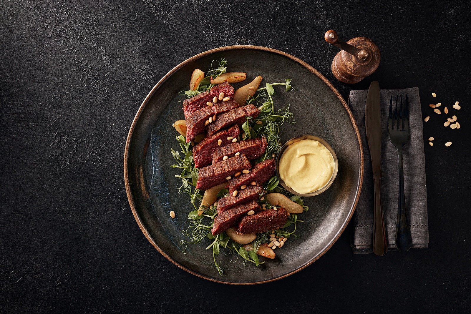Tender plant-based Redefine Flank steak served on a ceramic dinner plate